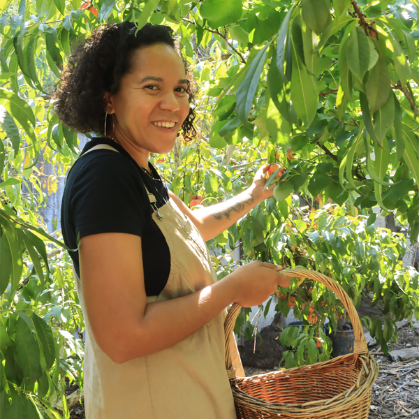 Alexys Romo harvesting fruit at her farm