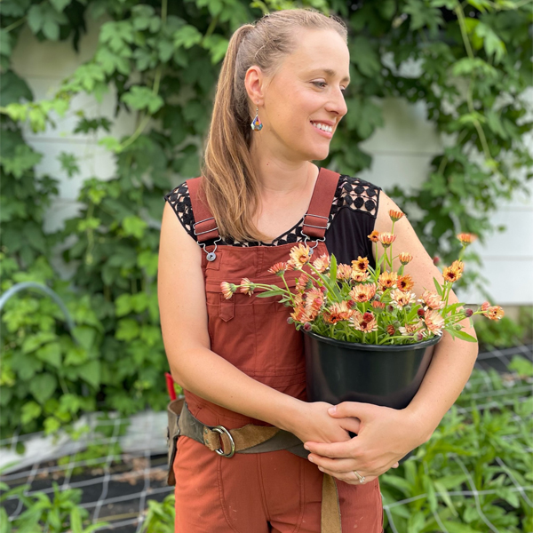 Leah Jirges holding bucket of flowers