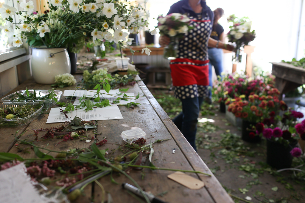 Close-up of a messy table in the Floret studio where Erin Benzakein is working with her daughter