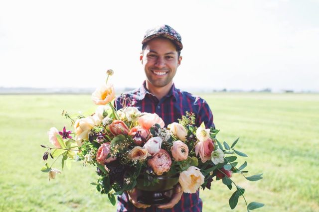 A man holding a flower arrangement