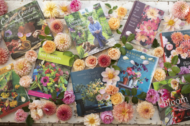 Overhead of Floret's favorite books surrounded by dahlias